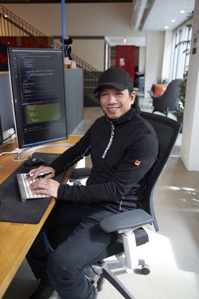 Developer working at a modern workstation with code on screen